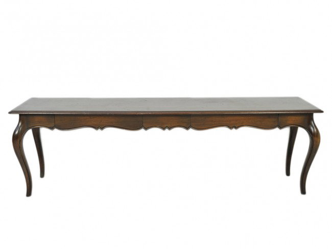AN AMERICAN FRENCH PROVINCIAL LONG WALNUT SOFA TAB: AN AMERICAN FRENCH PROVINCIAL LONG WALNUT SOFA TABLE with beveled molded edge; shaped molded apron concealing two flush front drawers to one side; made by Trouvailles Massachusetts 25 x 84 1/2 x 20 in