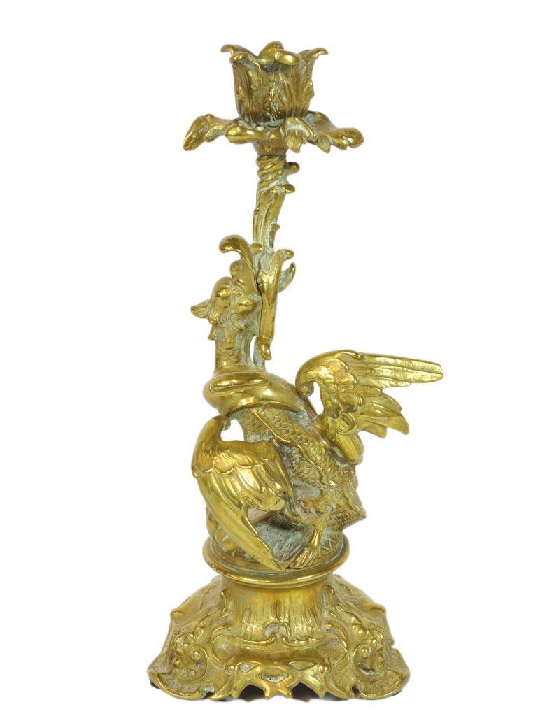 A SCULPTURAL GILT-METAL CANDLESTICK, Circa 1900: A SCULPTURAL GILT-METAL CANDLESTICK Circa 1900 The socket in the form of a flower and the stem formed from a dragon like bird holding the stem of the flower in his mouth on an auricular tripod base wi