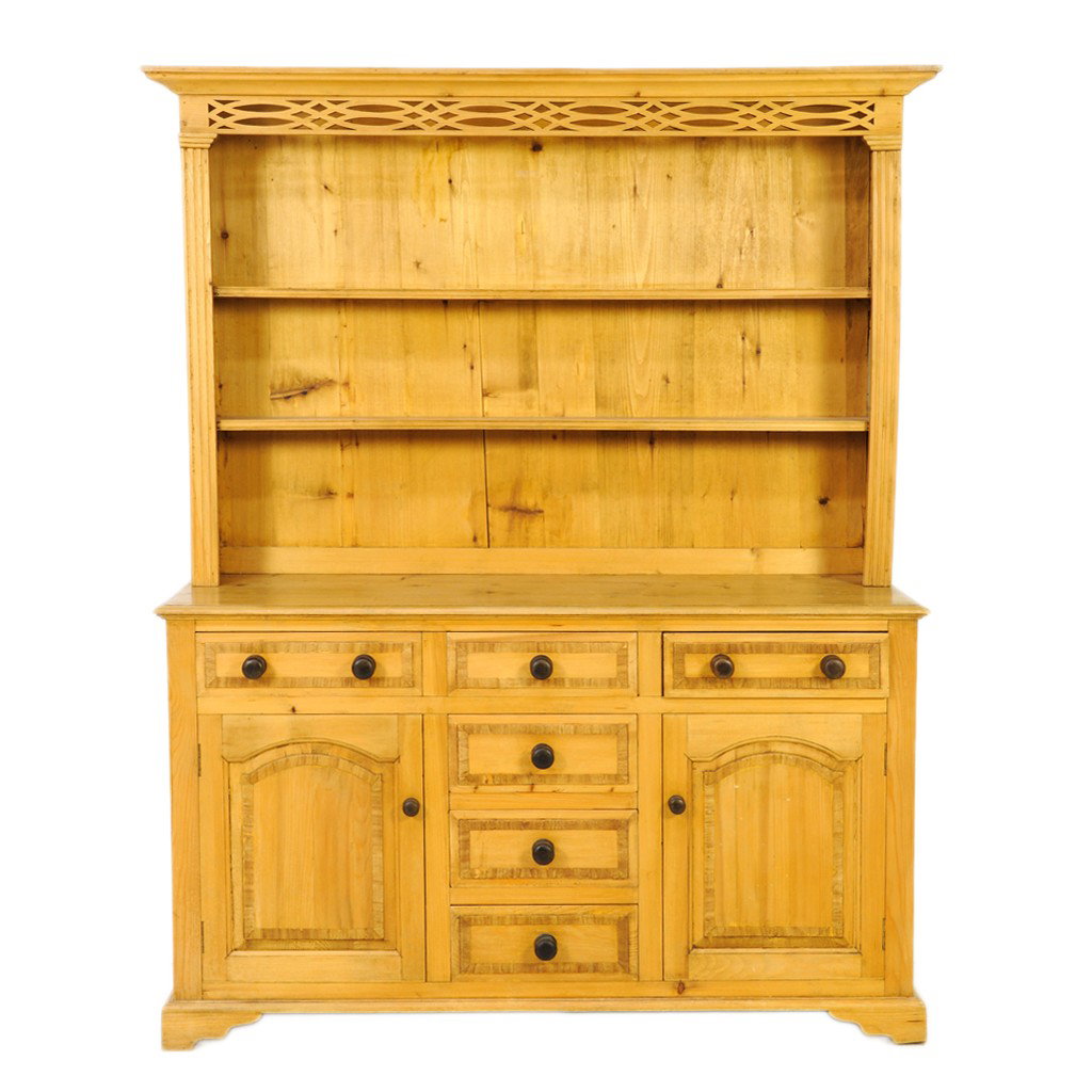 A NATURAL PINE HUTCH, Late Twentieth Century: A NATURAL PINE HUTCH Late Twentieth Century with pierced carved apron to cornice; open shelving; six drawers with cross grain veneer banding; two cabinet doors with inset arched panels with cross grai