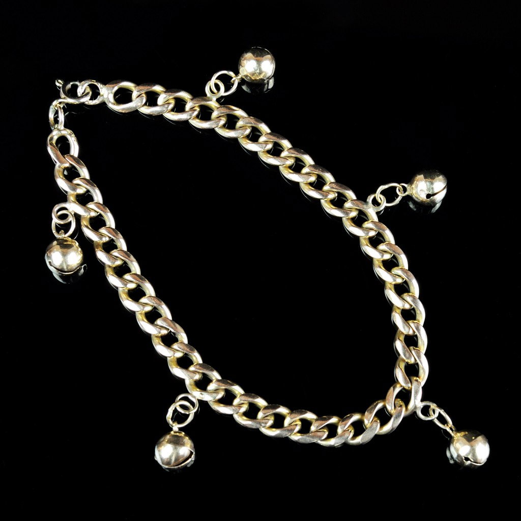 14KT JINGLE BELL CHARM BRACELET: 14KT JINGLE BELL CHARM BRACELET The dainty yellow gold bracelet is 8 "" in length. 5.7 mm curb link chain with 5 - 6.5 mm jingle bells. 22.1 grams.