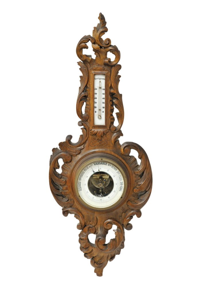 A FRENCH WALNUT BAROMETER France, Nineteenth Century: A FRENCH WALNUT BAROMETER France, Nineteenth Century The finely carved walnut barometer with sculptural case of exuberant volutes and scroll work throughout; the barometer ""Tempete cue pluie ou vt va