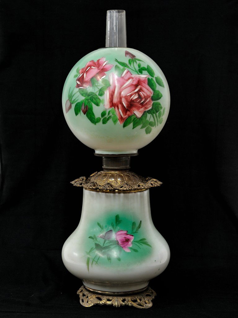 AN AMERICAN VICTORIAN "GONE WITH THE WIND" OIL TABL: AN AMERICAN VICTORIAN ""GONE WITH THE WIND"" OIL TABLE LAMP, 19th Centurykerosene-type; the glass shade and base of white glass with green, blue and pink coloration with hand painted floral reserve 21