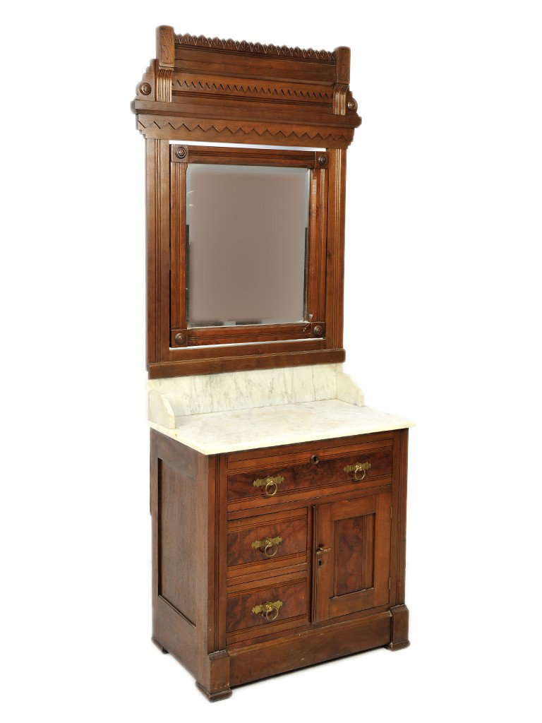 AN AMERICAN EASTLAKE WALNUT MARBLE TOPPED MIRRORED: AN AMERICAN EASTLAKE WALNUT MARBLE TOPPED MIRRORED WASH STAND, 19th Centurythe saw tooth incised carved cornice and frieze above original tilting mirror plate with reeded frame and rosette carved corn