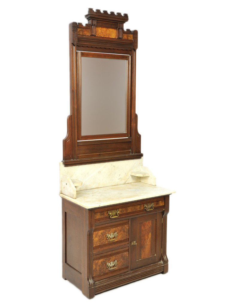 AN AMERICAN EAST LAKE WALNUT MARBLE TOPPED MIRRORE: AN AMERICAN EAST LAKE WALNUT MARBLE TOPPED MIRRORED WASH STANDthe saw tooth broken arch cornice and frieze above original tilting mirror plate with reeded frame; the white marble top with two shelves 