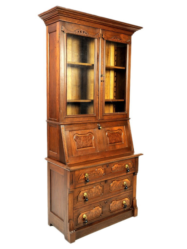 AN EASTLAKE WALNUT AND BURLED WALNUT DROP FRONT SE: AN EASTLAKE WALNUT AND BURLED WALNUT DROP FRONT SECRETARY BUREAU BOOKCASEthe step moulded cornice above glass doors; the drop front writing surface reveals maple fitted interior above the ogee moulded