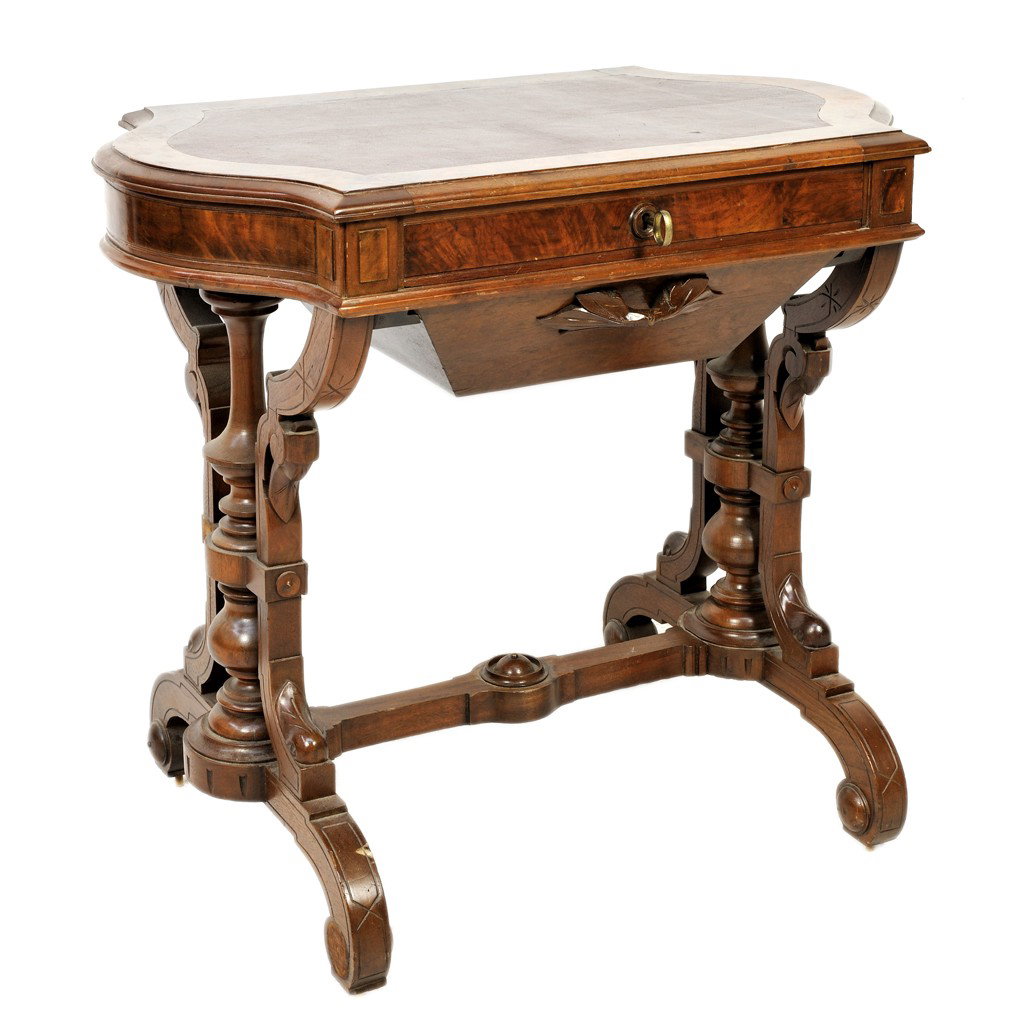 A WALNUT WRITING TABLE WITH INLAID LEATHER TOP: A WALNUT WRITING TABLE WITH INLAID LEATHER TOPwith shaped sides and burl veneer; drawer to apron; lower drawer compartment; carved h-stretcher 30 x 33 1/2 x 21 inches