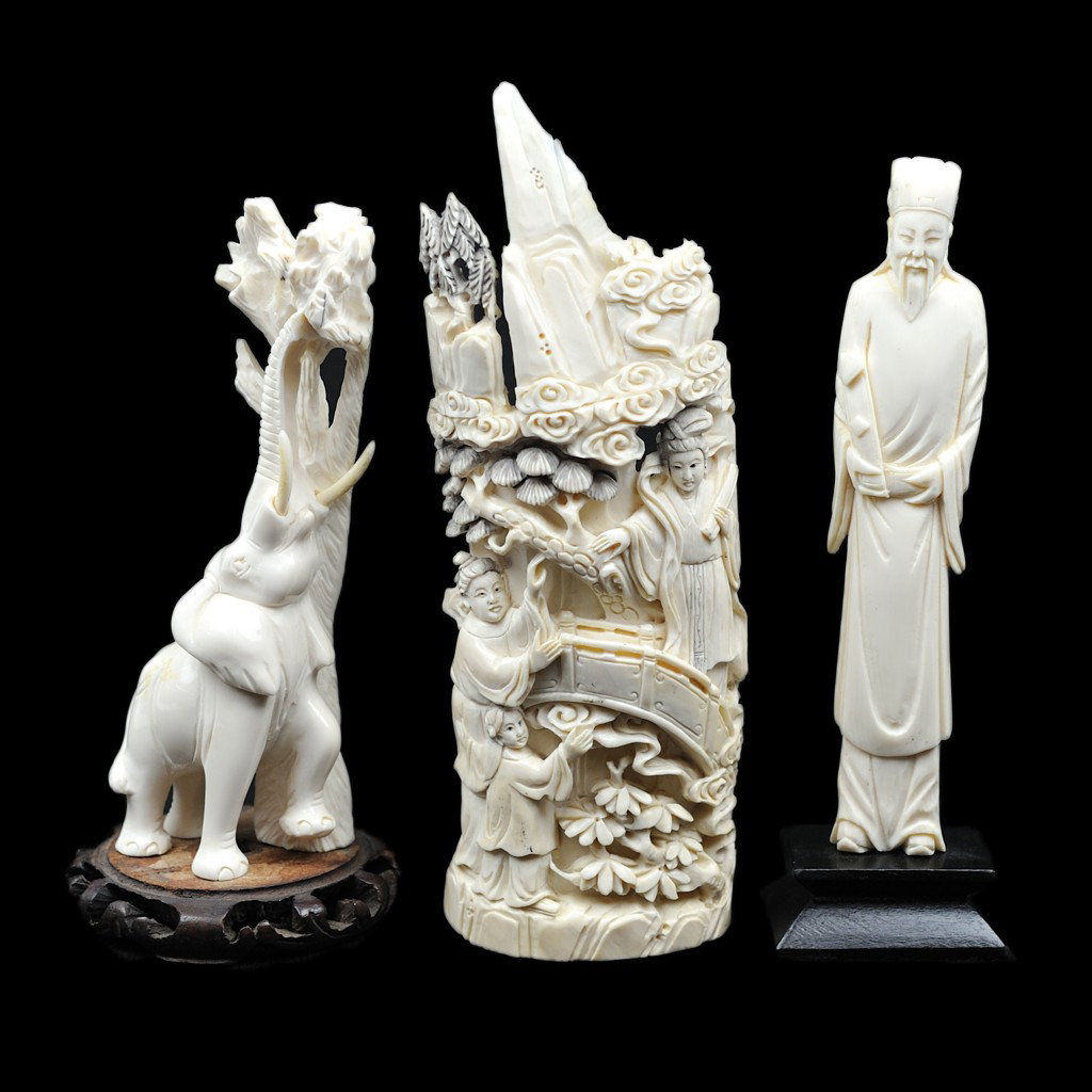 A GROUP OF THREE IVORY CARVINGS 3 pieces: A GROUP OF THREE IVORY CARVINGS the large Chinese ivory carving from a tusk; some breakage to top; carved verso; from an African tusk; signed underneath; a carving of a Chinese man holding a scroll; a