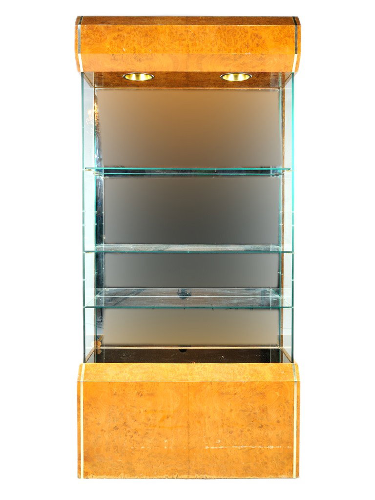 A BURLED WALNUT VENEERED LIGHTED DISPLAY WITH GLAS: A BURLED WALNUT VENEERED LIGHTED DISPLAY WITH GLASS SHELVES, Later 20th Century with two upper halogen lights; mirrored back; glass sides and adjustable height glass shelves; with brass trim; particle