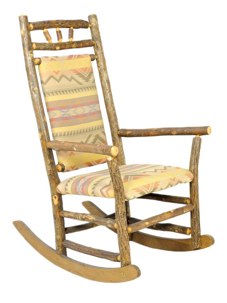 A NATURAL TREE LIMB UPHOLSTERED ROCKING CHAIR, Ame: A NATURAL TREE LIMB UPHOLSTERED ROCKING CHAIR, America, 20th Century the slightly arched crestrail above the frieze depicting a stylized sunrise flanked by natural tree limb circular uprights; the arm