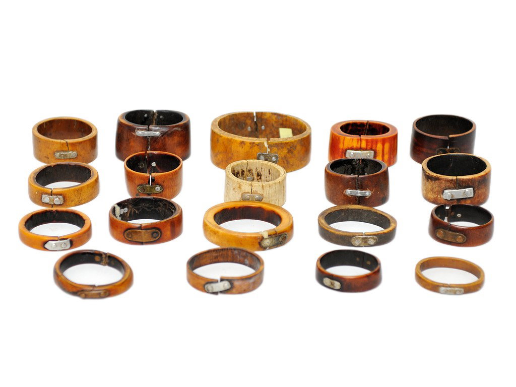 LOT OF 19 OLD AFRICAN ELEPHANT TUSK IVORY BRACELET: LOT OF 19 OLD AFRICAN ELEPHANT TUSK IVORY BRACELETS Each of the bracelets with one or two metal native mends where once broken; the colors ranging from dark brown to tan to cream, one with red-orange 