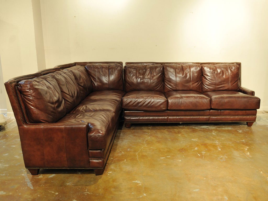 A LEATHER SECTIONAL SOFA WITH NAILHEAD TRIM MADE BY: A LEATHER SECTIONAL SOFA WITH NAILHEAD TRIM MADE BY SPECTRA HOME 37 x 81 x 36 inches and 37 x 92 x 36 inches
