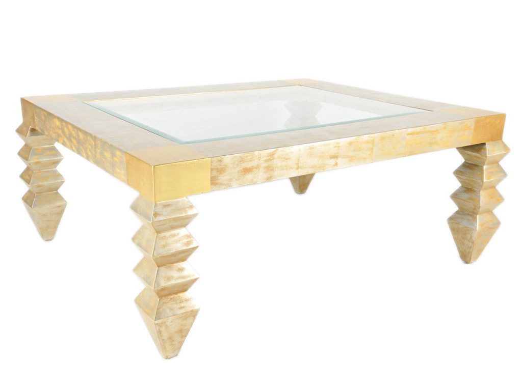 A CONTEMPORARY GOLD AND SILVER LEAF COFFEE TABLE 2: A CONTEMPORARY GOLD AND SILVER LEAF COFFEE TABLE 20th Century the inset glass top above the straight, flat apron, raised on jagged square legs ending in tapering block feet 20 x 50 x 41 1/2 inches