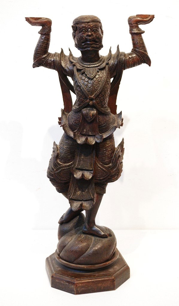 AN ANTIQUE SE ASIAN CARVED WOOD FIGURE: AN ANTIQUE SE ASIAN CARVED WOOD FIGURE Probably Indonesian or Malaysian. Previously drilled for adapting to a lamp. 29-1/2 x 13 x 9 inches