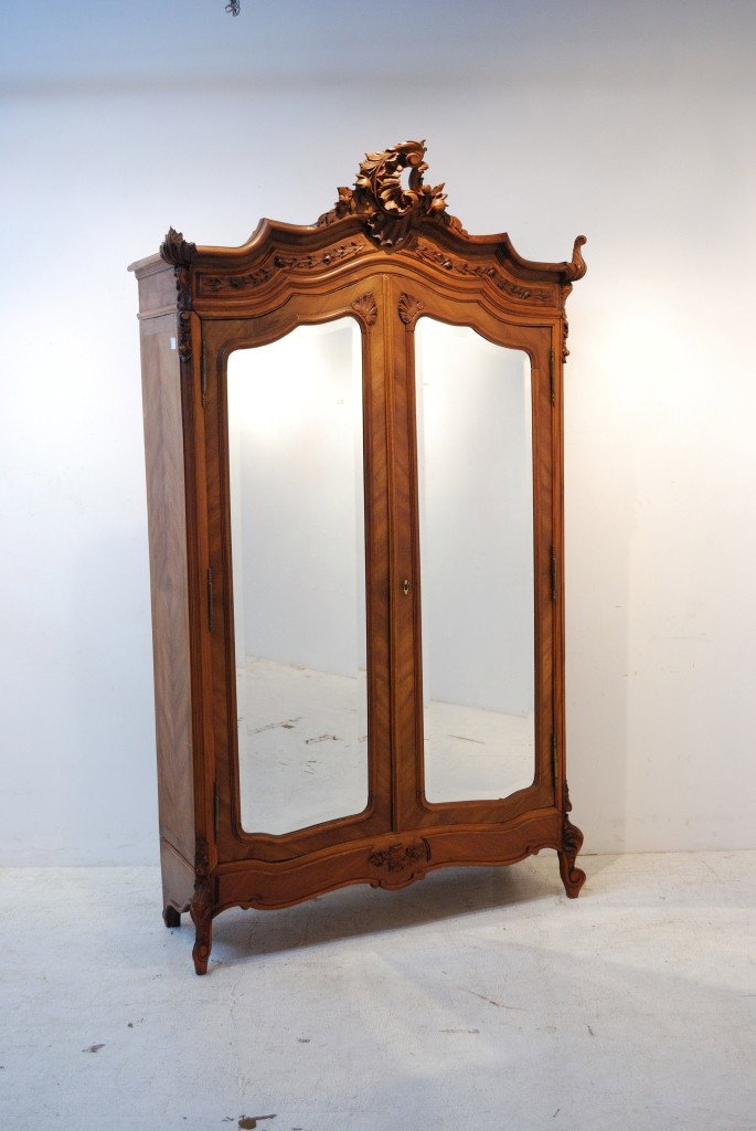 AN ANTIQUE LOUIS XVI STYLE WALNUT ARMOIRE: AN ANTIQUE LOUIS XVI STYLE WALNUT ARMOIRE Two doors fronted with beveled mirror panels 96 x 52 x 18 inches