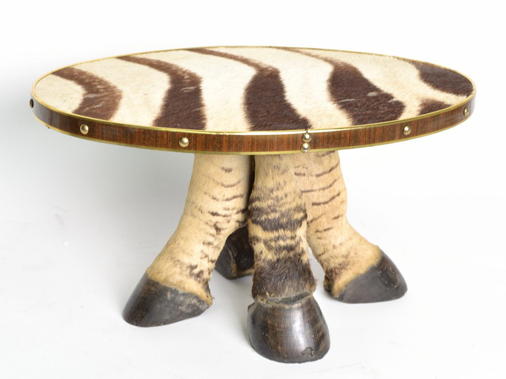 A ZEBRA HIDE AND HORN FOOTSTOOL: A ZEBRA HIDE AND HORN FOOTSTOOL 10 x 18-1/2 x 13 inches