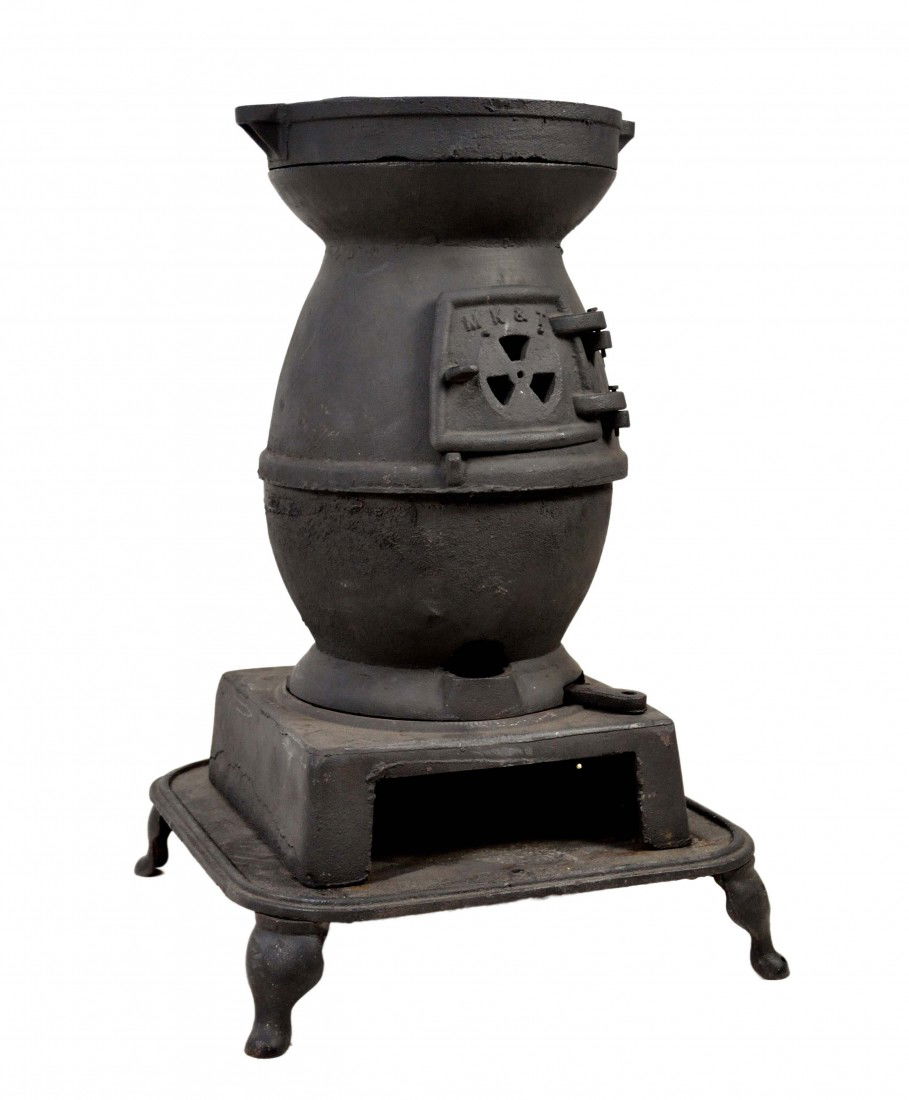 AN IRON POT BELLIED STOVE, MANUFACTURED BY MK&T: AN IRON POT BELLIED STOVE, MANUFACTURED BY MK&T 38 x 23 ½ x 23 ½ inches
