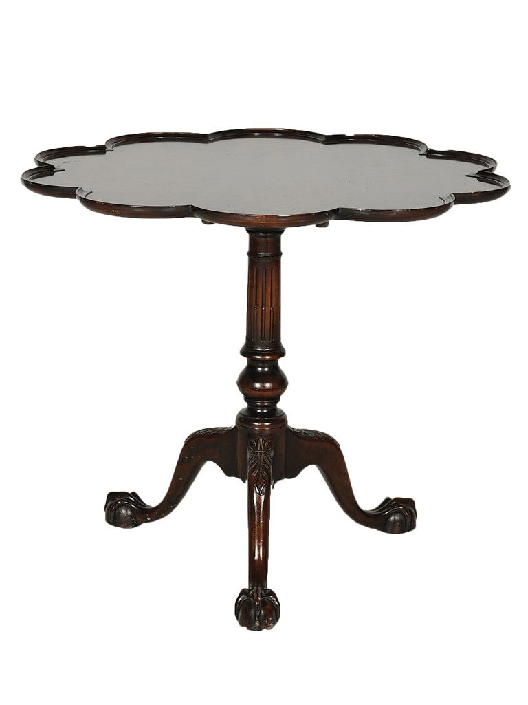 AN CHIPPENDALE STYLE MAHOGANY TILT TOP TEA TABLE 1: AN CHIPPENDALE STYLE MAHOGANY TILT TOP TEA TABLE 19th Century The ribbon mahogany, tart tin shaped top with pie crust edge is supported by a column with a locking, tilting mechanism; the pedestal is t