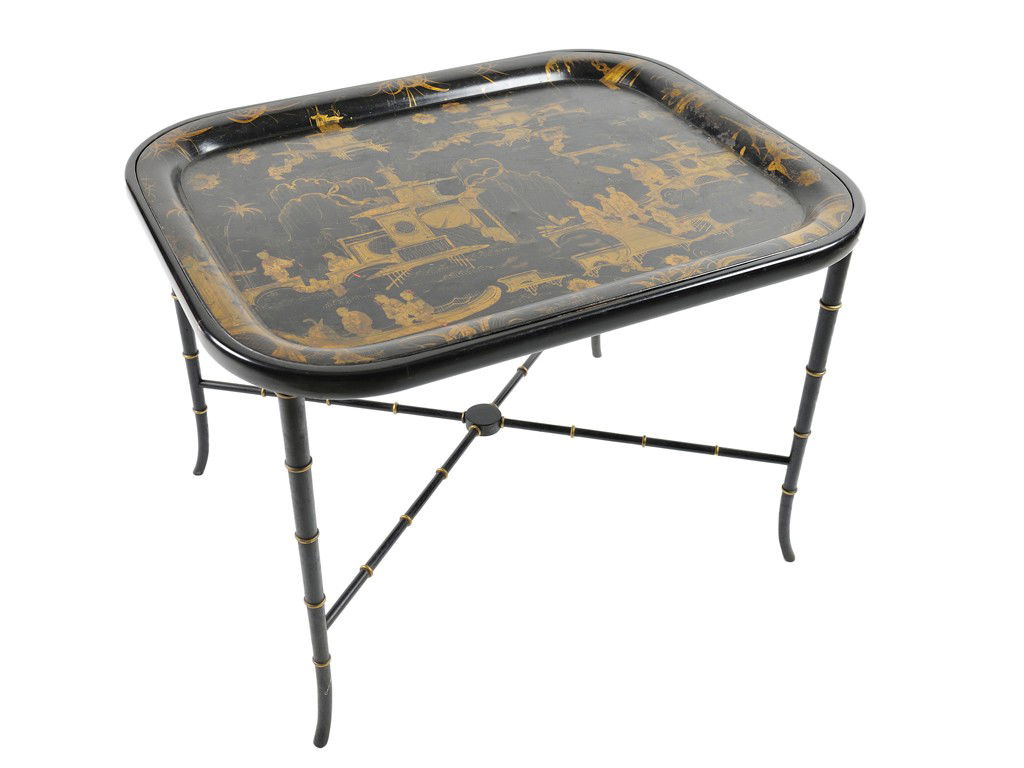 A BLACK AND GILT CHINOISERIE TOLE TRAY TABLE Franc: A BLACK AND GILT CHINOISERIE TOLE TRAY TABLE France, Mid 19th Century metal tray with wide lip and completely decorated with outdoor chinese scenes, raised on a delicate base with X-form stretcher wit