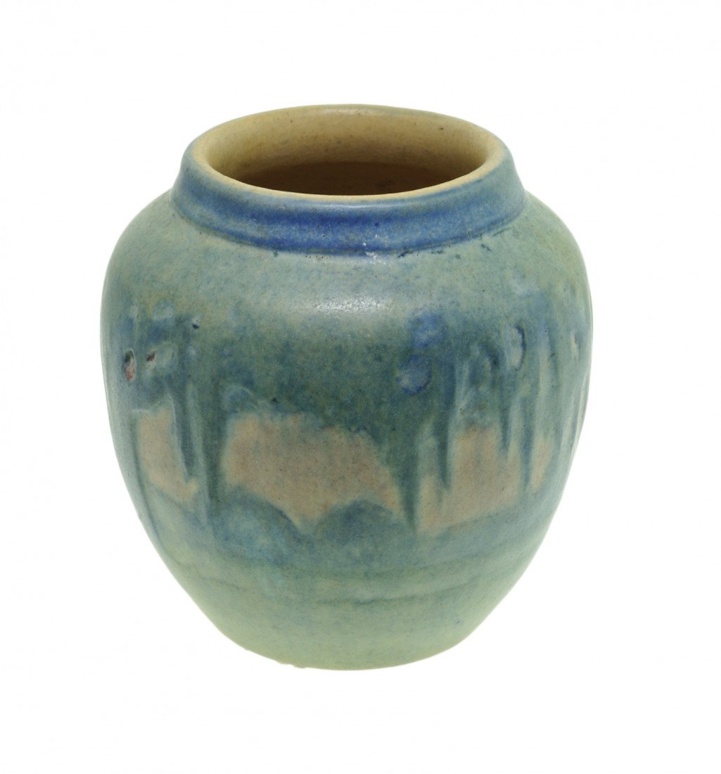 A SMALL GLAZED NEWCOMB ART POTTERY VASE, 1921: A SMALL GLAZED NEWCOMB ART POTTERY VASE, 1921 The small Newcomb College Pottery vase having a thick pale aqua and blue glaze against a gray ground, depicting a Southern landscape of live oak trees dra