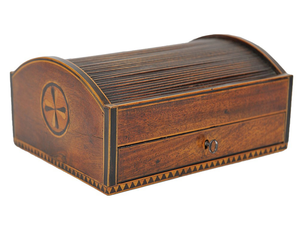 A GENTLEMAN'S SHERATON STYLE MAHOGANY TAMBOUR VANI: A GENTLEMAN'S SHERATON STYLE MAHOGANY TAMBOUR VANITY BOX England, 19th Century stylized heart inlays of ebony and satinwood with blue paper lining. as drawers slide open, tambour lid opens to reveal s