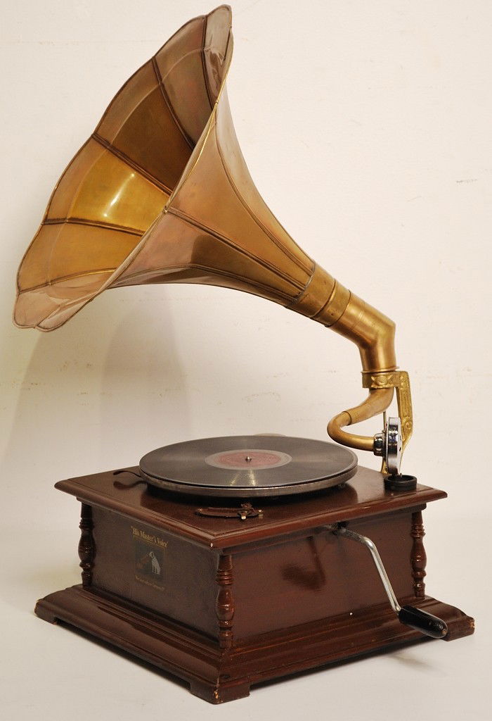 A VINTAGE RECONDITIONED GRAMAPHONE RECORD PLAYER: A VINTAGE RECONDITIONED GRAMAPHONE RECORD PLAYER With a brass horn 28 ½ x 19 ½ x 18 inches