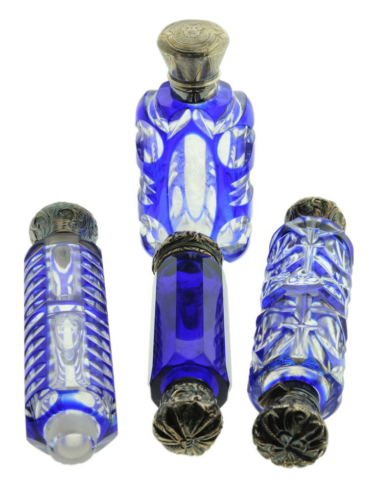 LOT OF FOUR VICTORICAN COBALT CUT GLASS PERFUME BOT: LOT OF FOUR VICTORICAN COBALT CUT GLASS PERFUME BOTTLES WITH SILVER CAPS Late 1800s -early 1900s Late 1800s-early 1900s The lot consisting of: (1) a cobalt cut-to-clear crystal flask with an unmarked 