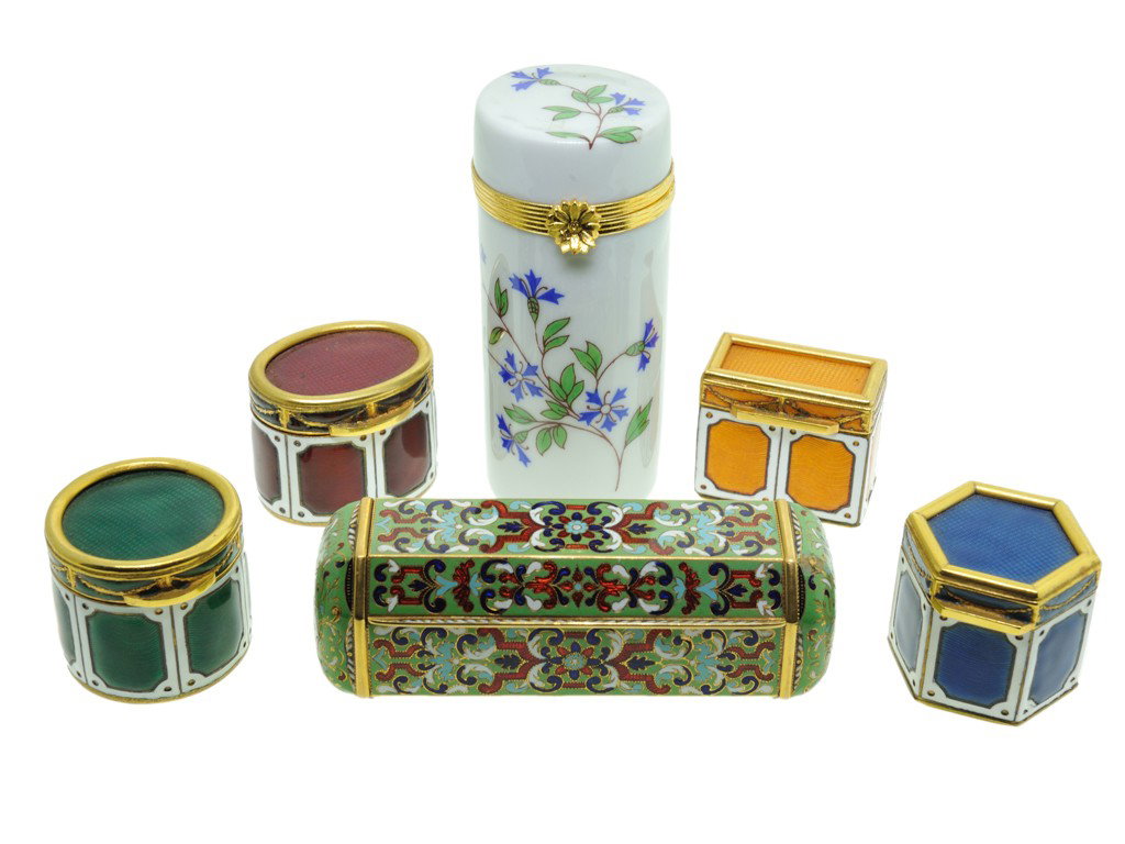 LOT OF SIX SMALL ENAMELED LIDDED CONTAINERS: LOT OF SIX SMALL ENAMELED LIDDED CONTAINERS The lot of six small containers consisting of: (1) a tall cylindrical white porcelain Limoges lidded box decorated with sprays of blue enamel flowers, the h