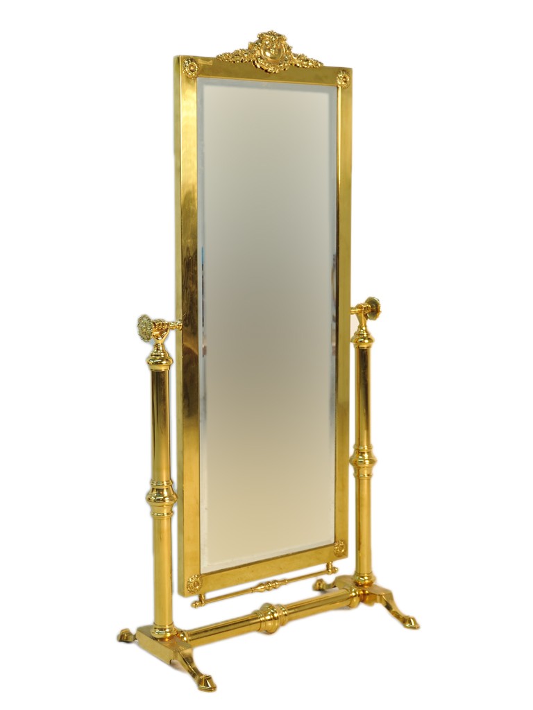 FRENCH CHEVAL BRASS AND BEVELED MIRROR ON STAND: FRENCH CHEVAL BRASS AND BEVELED MIRROR ON STAND Cast brass with corner rosettes and cast festoon on cornice. Cast rosette adjustment knobs. Starburst relief on base of stand. 67 1/2 x 33 x 19 inches