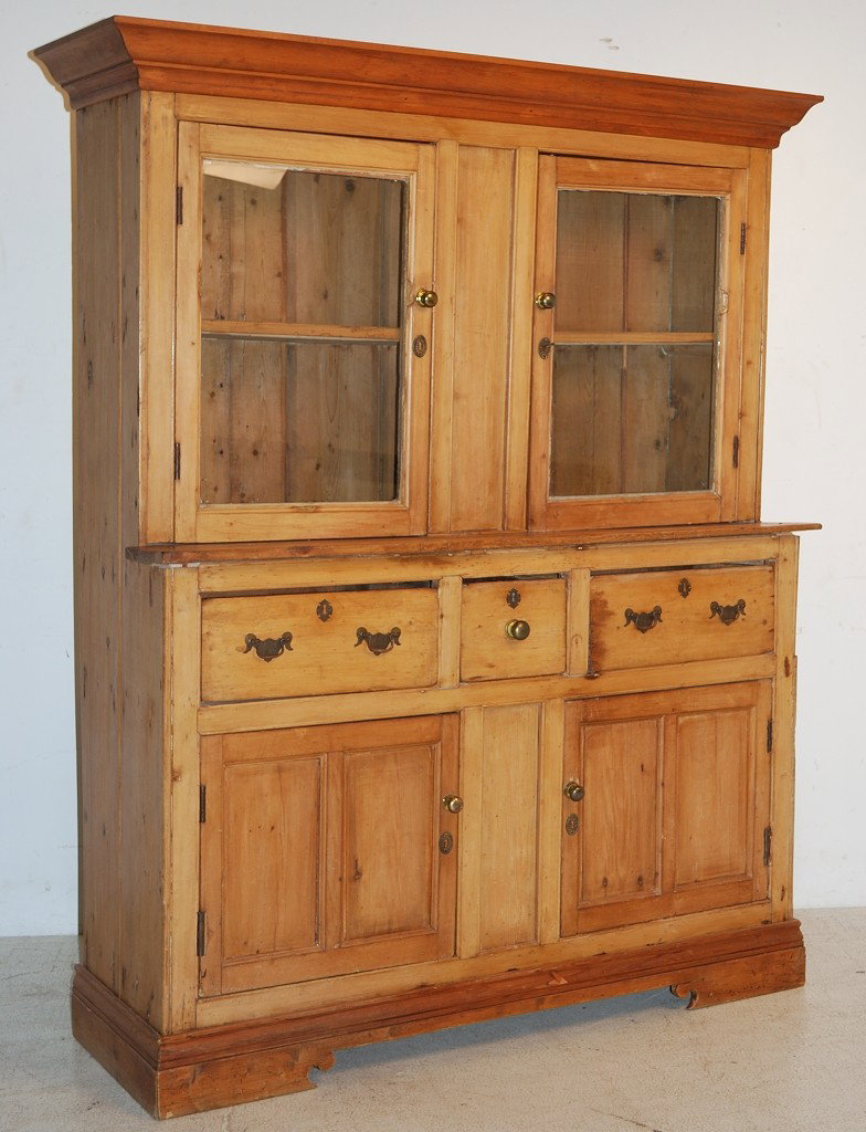 AN ANTIQUE PINE PRIMITIVE HUTCH: AN ANTIQUE PINE PRIMITIVE HUTCH Possibly English. Top with 2 glazed cabinet doors over base section with 2 solid doors. 74 x 62 x 19 ½ inches