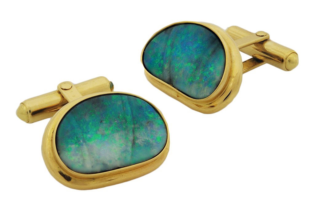 A PAIR OF 18K BOULDER OPAL CUFFLINKS BY WHITE: A PAIR OF 18K BOULDER OPAL CUFFLINKS BY WHITE In yellow gold with oval, free-form carved kidney shaped boulder opal weighing approx 5.00 Ct. total weight. One opal exhibits a minor fracture. 14.9 gram