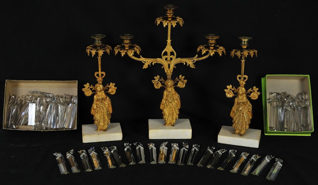A 3 PIECE GILT BRASS GARNITURE SET - CANDELEBRA W/ PRIS: A 3 PIECE GILT BRASS GARNITURE SET - CANDELEBRA W/ PRISMS Most prisms present; some lacking small hanging hooks18 ½ x 15 ½ x 4½ inches