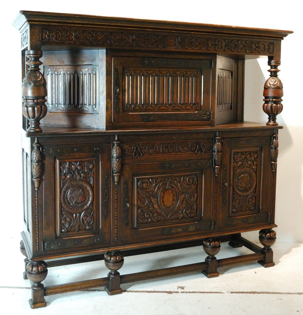 A VINTAGE RENAISSANCE REVIVAL FUMED OAK BUFFET: A VINTAGE RENAISSANCE REVIVAL FUMED OAK BUFFET Having a super color and patina. The upper panels with linenfold carving. Early 20th century 70 X 72 X 20 inches