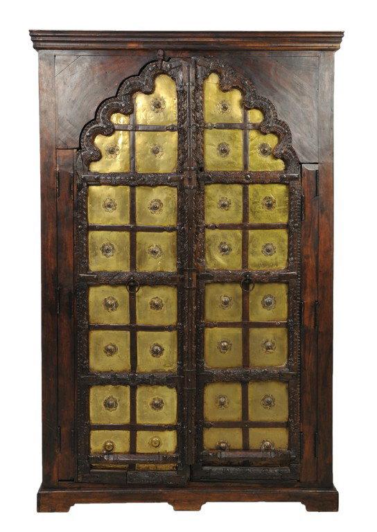 A MOROCCAN STYLE HARDWOOD AND BRASS TWO DOOR TALL : A MOROCCAN STYLE HARDWOOD AND BRASS TWO DOOR TALL CABINET 19th Century The rectilinear molded cornice is supported by a conforming body housing a lobed, arched opening supporting a pair of 19th Centur