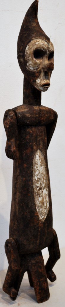 A YAKA TRIBE FETISH FIGURE - ZAIRE: A YAKA TRIBE FETISH FIGURE - ZAIRE With articulated arms and legs. Large cavity in back for reliquary. 29 ½ x 6 ½ x 4 inches