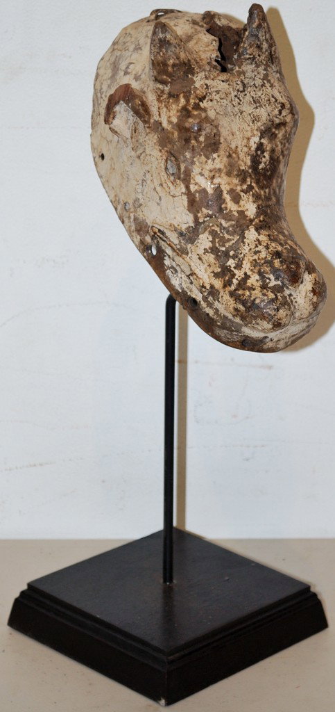 AN AFRICAN HEADDRESS MASK: AN AFRICAN HEADDRESS MASK Possibly Ogoni tribe of Nigeria. With old staple repairs. 19 x 7 x 9 inches