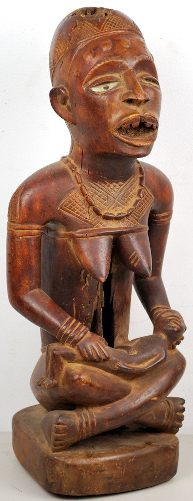 A YOMBE TRIBE FIGURE - ZAIRE: A YOMBE TRIBE FIGURE - ZAIRE With glass eyes. 26 x 10 x 9 inches