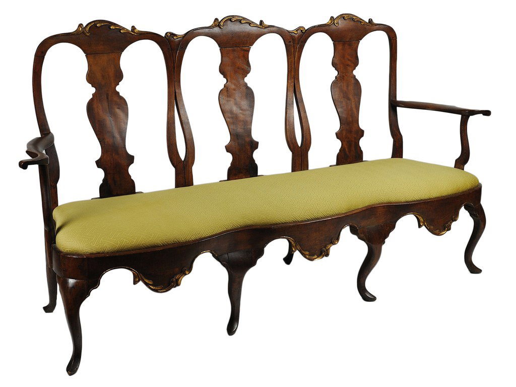 A FINE ITALIAN BAROQUE PARCEL GILT WALNUT SETTEE It: A FINE ITALIAN BAROQUE PARCEL GILT WALNUT SETTEE Italy, Late 18th Century The triple humpback crest rail with foliate gilded carving above the vasiform back splats flanked by slightly scrolling interl