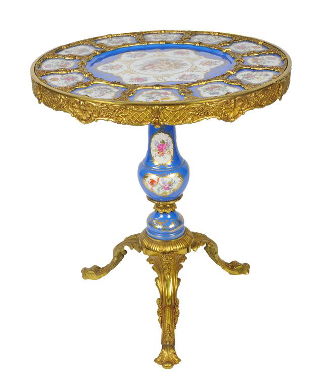 A SEVRES STYLE PORCELAIN CHARGER AND GILT BRONZE CI: A SEVRES STYLE PORCELAIN CHARGER AND GILT BRONZE CIRCULAR SIDE TABLE Marked with interlacing L's in the underglaze with a D in the center The large twenty six inch diameter charger is graced with a ce