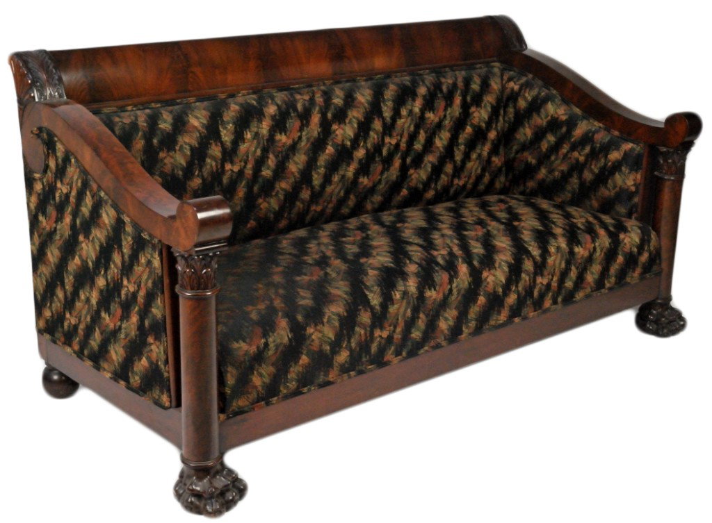 A BOLD AMERICAN EMPIRE STYLE MAHOGANY SOFA Lake Cha: A BOLD AMERICAN EMPIRE STYLE MAHOGANY SOFA Lake Charles, Louisiana, Circa 1900 The rectilinear scrolled crest rail of figured mahogany is flanked by carved shoulders and thick scroll form high arms wi