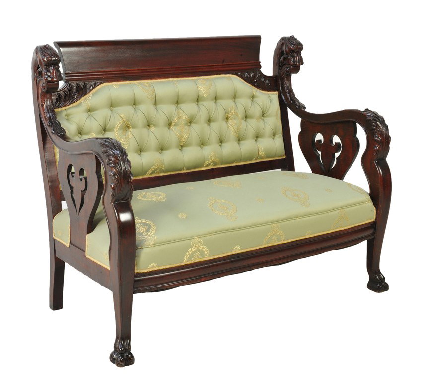 AN AMERICAN MAHOGANY VICTORIAN SETTEE Early 20th C: AN AMERICAN MAHOGANY VICTORIAN SETTEE Early 20th Century In the style of J. B. Horner The scroll solid crest is supported by a hand carved acanthus in relief and flanked by a pair of carved dragon hea