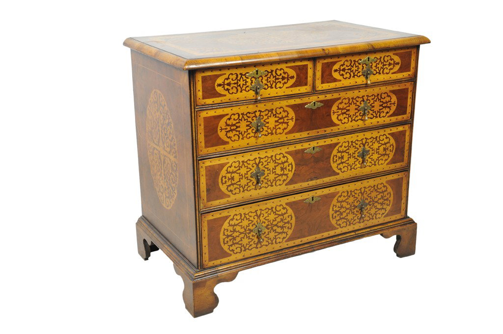 A WILLIAM AND MARY STYLE SEAWEED MARQUETRY FIVE DR: A WILLIAM AND MARY STYLE SEAWEED MARQUETRY FIVE DRAWER CHEST Continental, Late 18th/Early 19th Century The burl walnut top is inlaid with an inlaid maple frame with seaweed marquetry brackets and cent