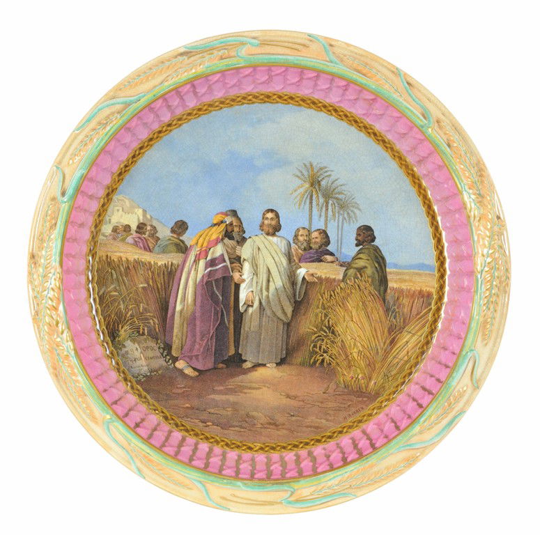 A CONTINENTAL MOULDED, GILDED, AND DECORATED EARTH: A CONTINENTAL MOULDED, GILDED, AND DECORATED EARTHENWARE PLATE WITH BIBLICAL SCENE Probably England, Late 19th Century The circular plate having a central transfer-printed scene depicting Jesus in a f