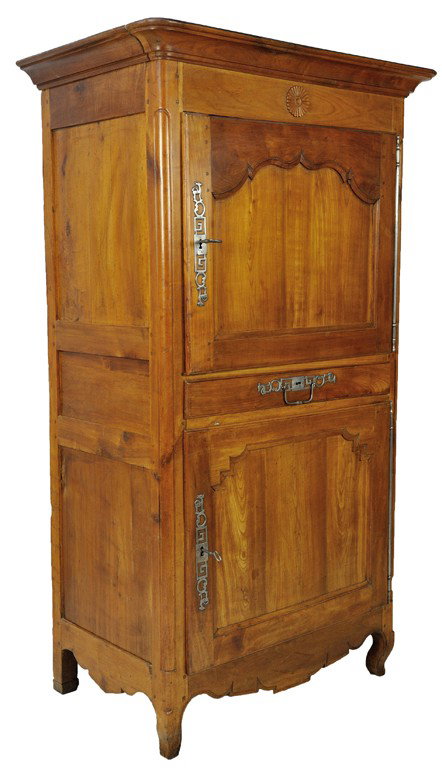 A FRUITWOOD TWO DOOR VENDEE CABINET: A FRUITWOOD TWO DOOR VENDEE CABINET The molded cornice is supported by a rectilinear conforming body featuring two large doors, each featuring a different shaped recessed panel, pierced escutcheons an