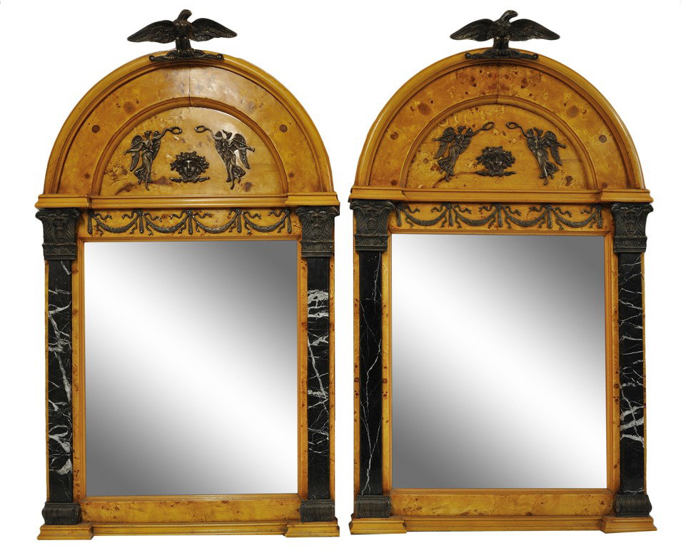 A PAIR OF EMPIRE STYLE MIRRORS WITH BRONZE MOUNTS: A PAIR OF EMPIRE STYLE MIRRORS WITH BRONZE MOUNTS The bold arched cornice in burled yew wood veneer is adorned with proud bronze eagles, stars and a reserve of trumpeting angels flanking the face of M