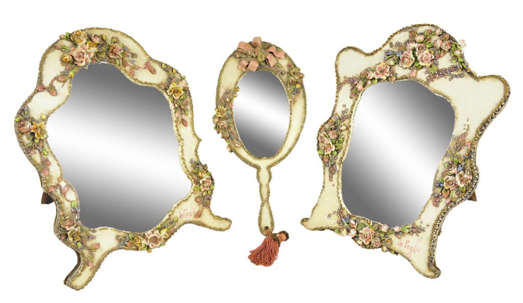A GROUP OF THREE CAPODIMONTE MIRRORS Early 20th Ce: A GROUP OF THREE CAPODIMONTE MIRRORS Early 20th Century, Signed De Pegie The group consists of two shaped table mirrors with white matte porcelain frames decorated with small cast and painted floral b