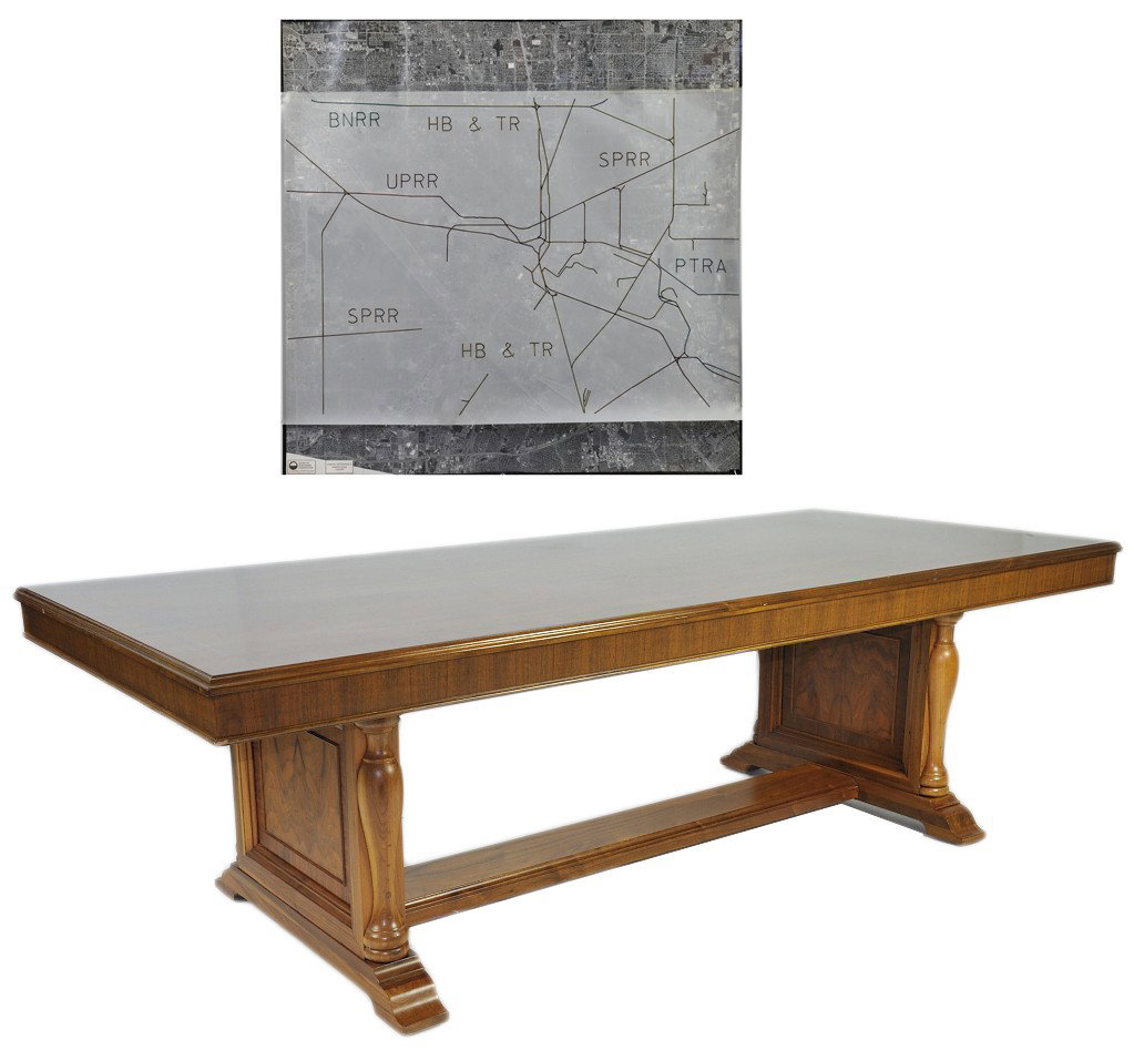A LARGE WALNUT DOUBLE PEDESTAL CONFERENCE TABLE FROM: A LARGE WALNUT DOUBLE PEDESTAL CONFERENCE TABLE FROM THE OLD UNION PACIFIC BUILDING Accompanied by an aerial view plat of Railroad trunk lines. 30 x 95½ x 41½ inches