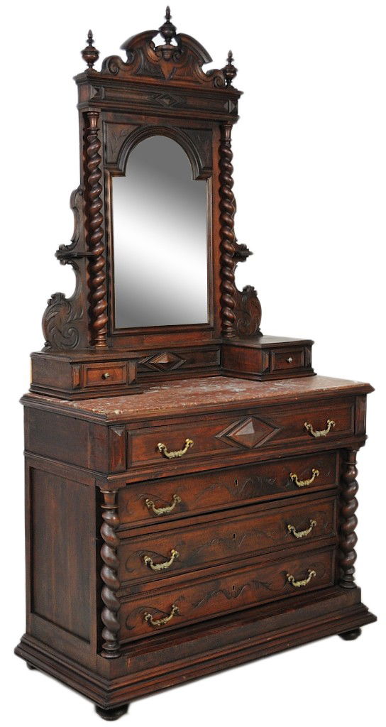 A HENRI II CARVED WALNUT DRESSER WITH INCISED CARVI: A HENRI II CARVED WALNUT DRESSER WITH INCISED CARVINGS AND TURNED COLUMNS 90½ x 47 x 20½ inches