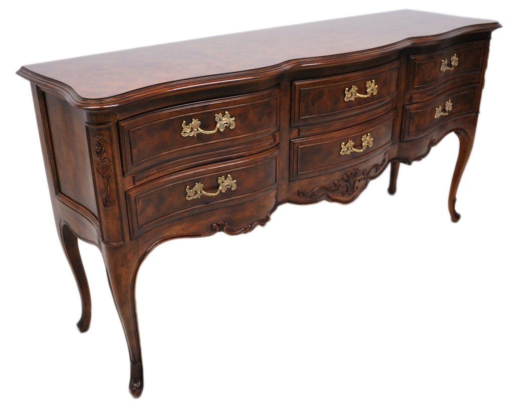A FRENCH PROVENCAL SIDEBOARD BY DREXEL HERITAGE: A FRENCH PROVENCAL SIDEBOARD BY DREXEL HERITAGE From the ""Old Continents"" collection. The six drawer sideboard features cabriole legs with a scalloped and shaped apron having applied carvings. The u
