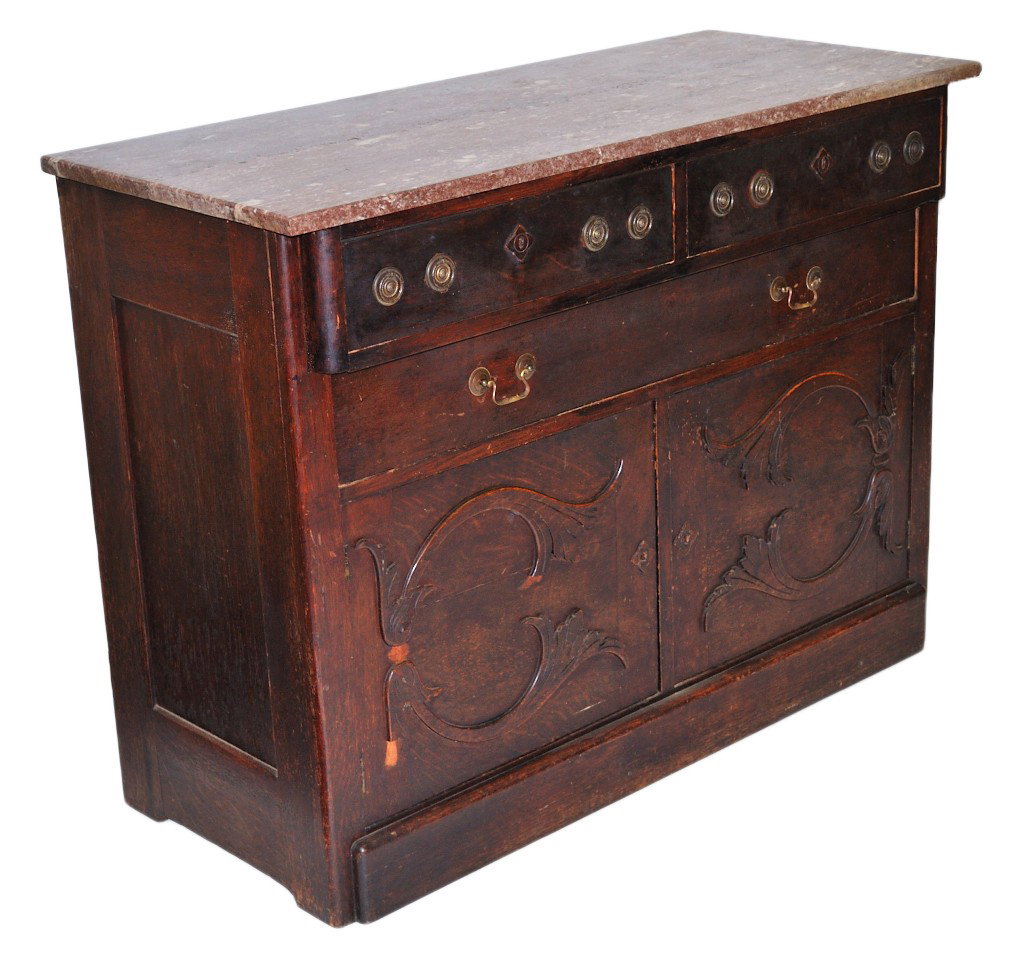 AN AMERICAN OAK MARBLE TOP SIDEBOARD: AN AMERICAN OAK MARBLE TOP SIDEBOARD Late 19th/early 20th century. The two upper drawers retain remnants of a cloth lining along with a full length drawer in the middle, they both have later replaced 