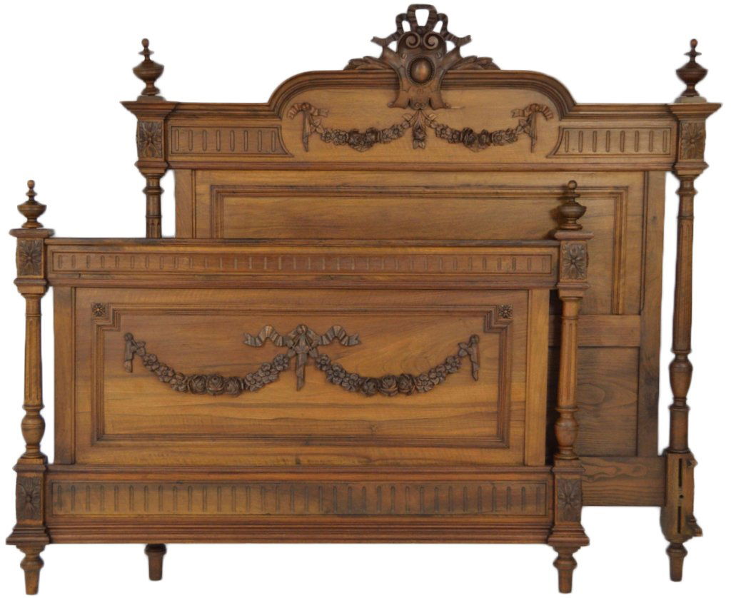 A GOOD LOUIS XVI STYLE BED IN WALNUT: A GOOD LOUIS XVI STYLE BED IN WALNUT Carved floral swags with ribbons decorate the headboard and footboard with bands of fluting above and below. A central carved cartouche decorates the headboard wit